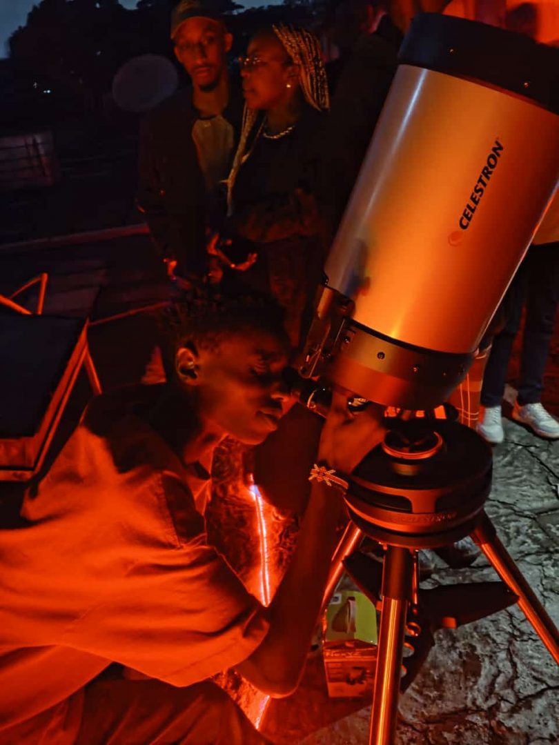A UoN AstroNight attendee looking through a Celestron C8
