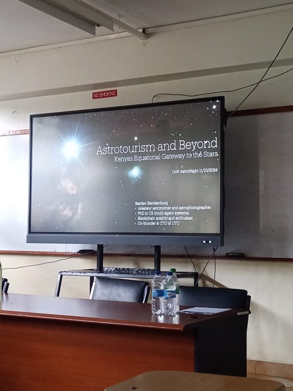The screen in the lecture room showing the title slide of my presentation.